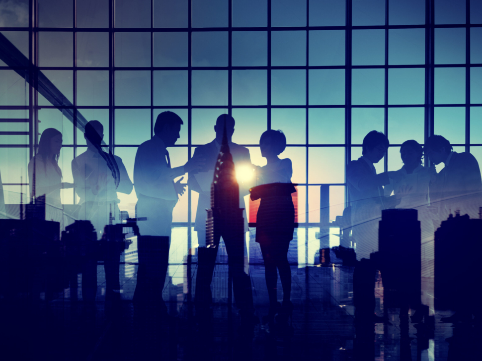 Group of business people brainstorming with silhouette sunset